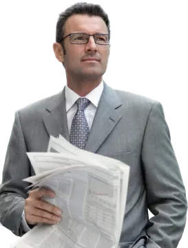 a man in a suit and tie reading a newspaper