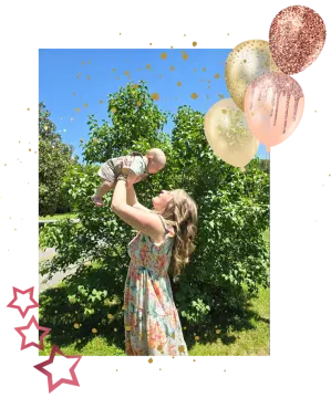 a little girl in a floral dress with balloons