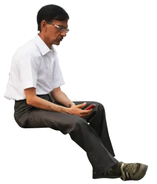 a man in white shirt and black pants sitting on the ground