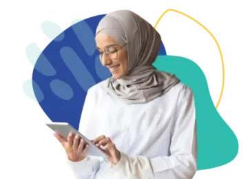 a woman wearing a headscar and looking at her tablet
