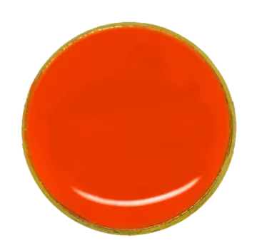 a red button with gold trim