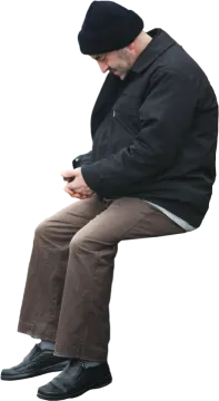 a man sitting on a bench using his cell