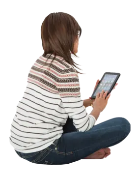 a woman sitting on the floor using her tablet