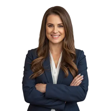 a woman in a business suit with her arms crossed