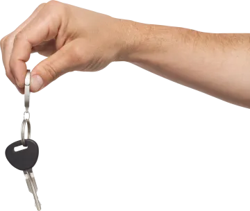 a man's hand holding a car key