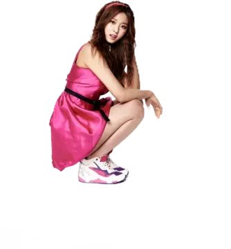 a woman in a pink dress sitting on the floor