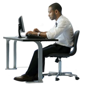 a man sitting at a desk using a laptop