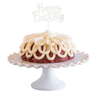 a red velvet cake with white frosting and a happy birthday candle