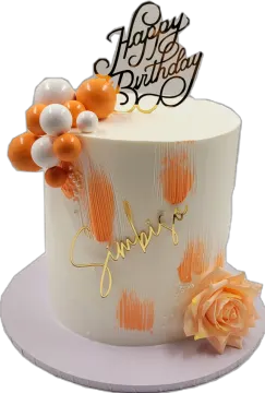 a white cake with orange and gold decorations