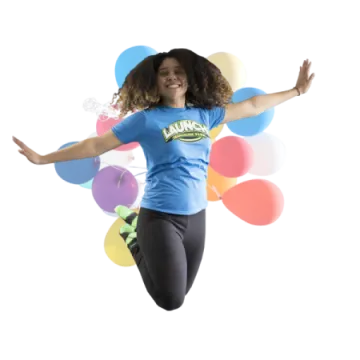 a woman jumping in the air with balloons