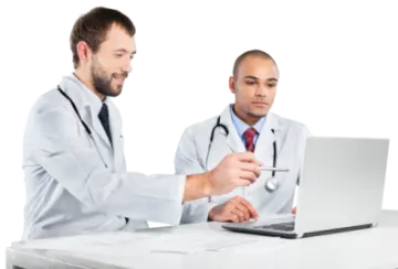 two doctors looking at a laptop computer