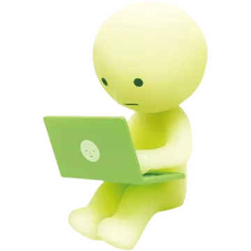 a small figure sitting on top of a laptop