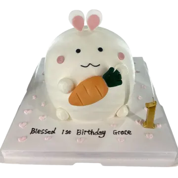 a birthday cake with a white bunny holding a carrot