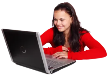 a woman sitting at a table with a laptop