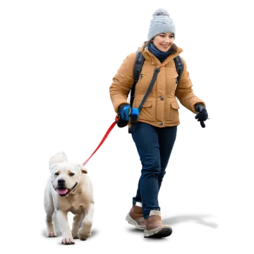 a woman walking a dog on a leash