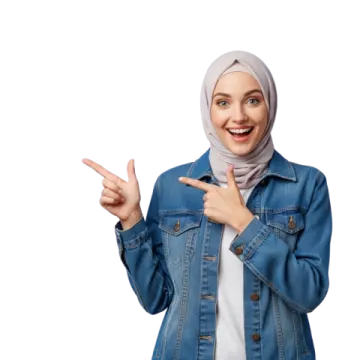 a woman in a denim jacket pointing at the camera