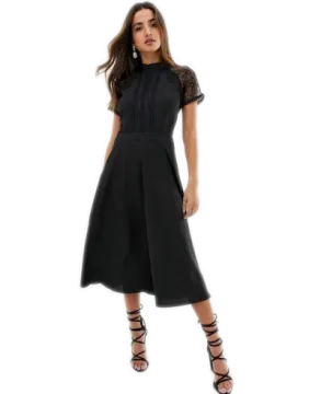 a woman wearing a black dress and sandals