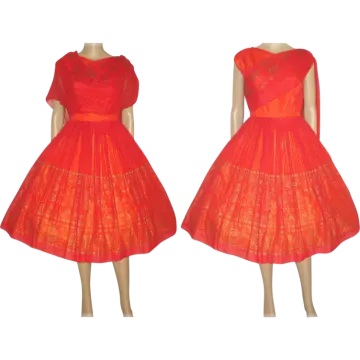 a red dress with gold embroidery on the shoulders