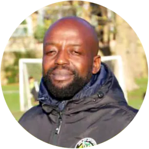 a man in a black jacket is smiling at the camera