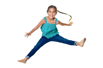 a little girl jumping in the air