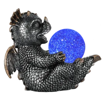 a black dragon holding a blue crystal ball