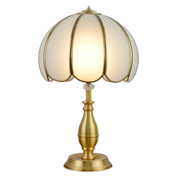 a brass table lamp with a white glass shade