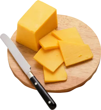 a piece of cheese on a cutting board with a knife