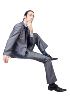a man in a suit and tie sitting on the floor