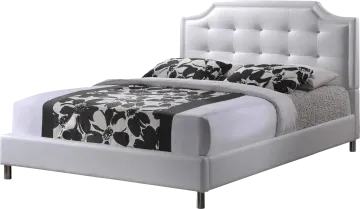 a white bed with black and white pillows