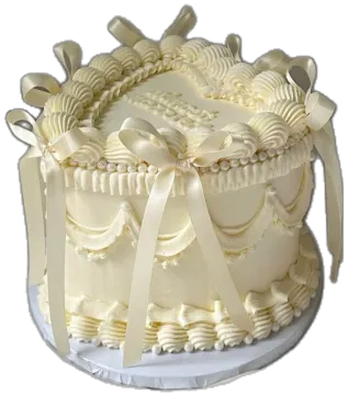 a cake with white frosting and bows