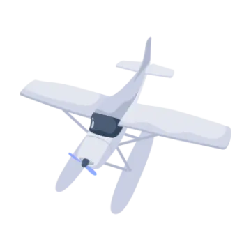 a small white airplane flying through the air