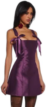 a woman wearing a purple dress with a bow