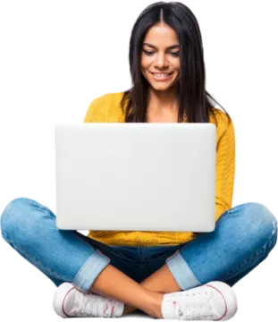 a woman sitting on the floor with her laptop