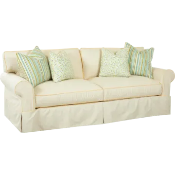 a white couch with blue and green pillows
