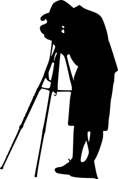 a silhouette of a man looking through a telescope