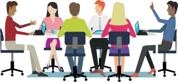 a group of people sitting at a table with laptops