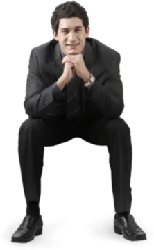 a man in a suit and tie sitting on the ground