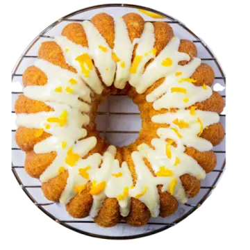 a cake on a wire rack with frosting