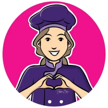 a woman in a chef's uniform making a heart shape