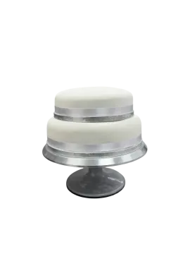 a white cake sitting on top of a metal stand