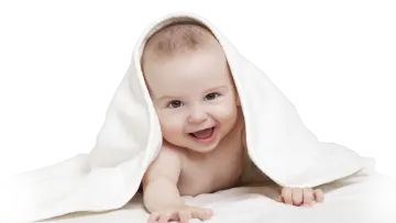 a smiling baby under a white blanket