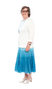 a woman in a white sweater and blue skirt