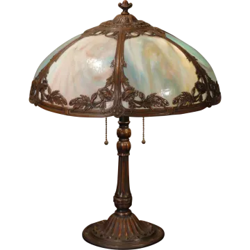 an antique table lamp with a glass shade