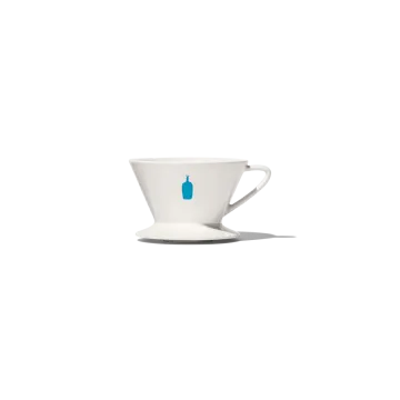 a white coffee cup with a blue handle