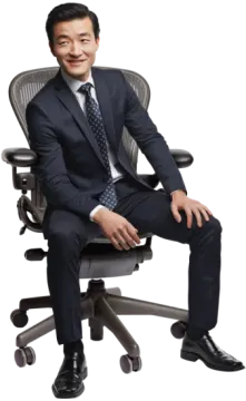 a man in a suit sitting on a chair