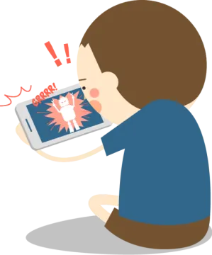 a boy sitting on the floor looking at his phone