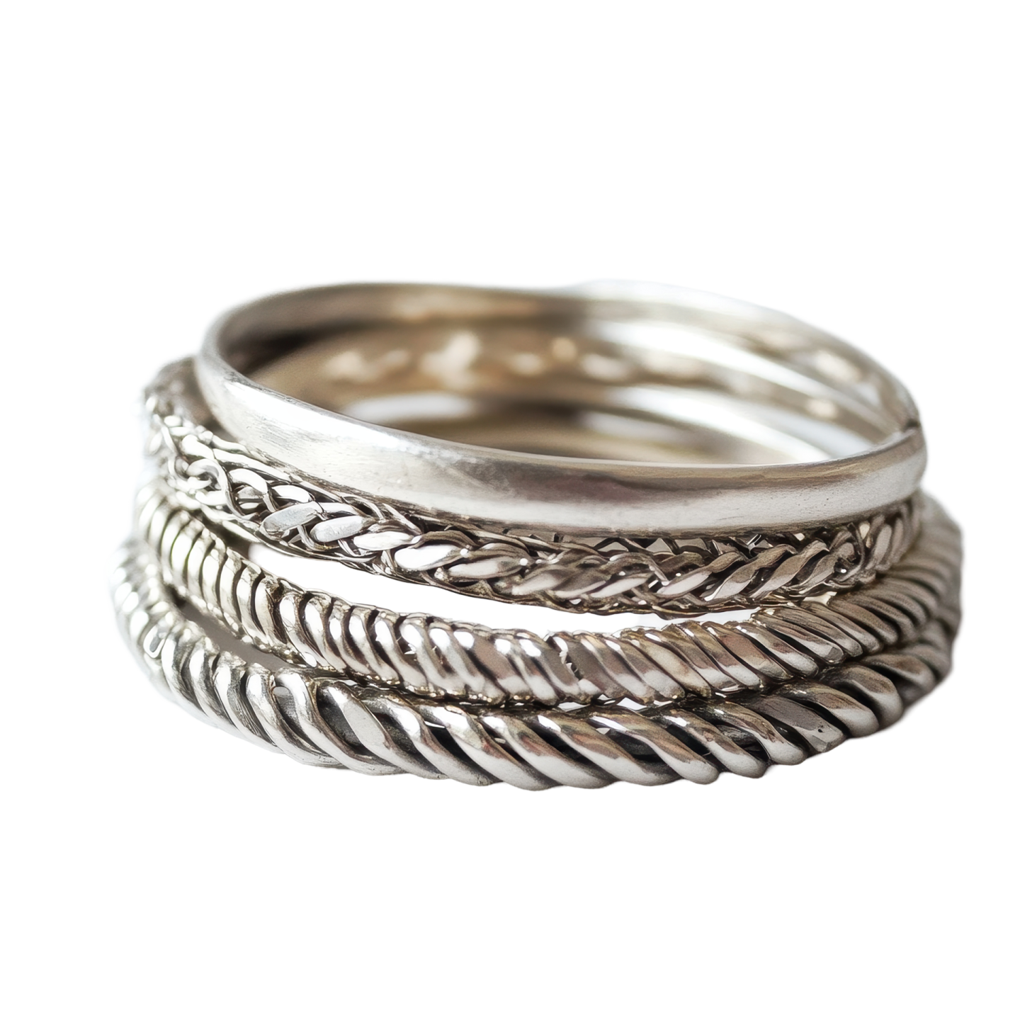 a stack of silver rings on white background