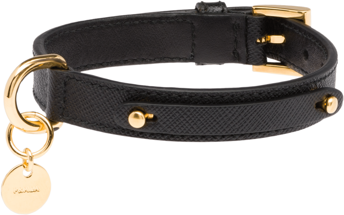 a black leather bracelet with a gold charm