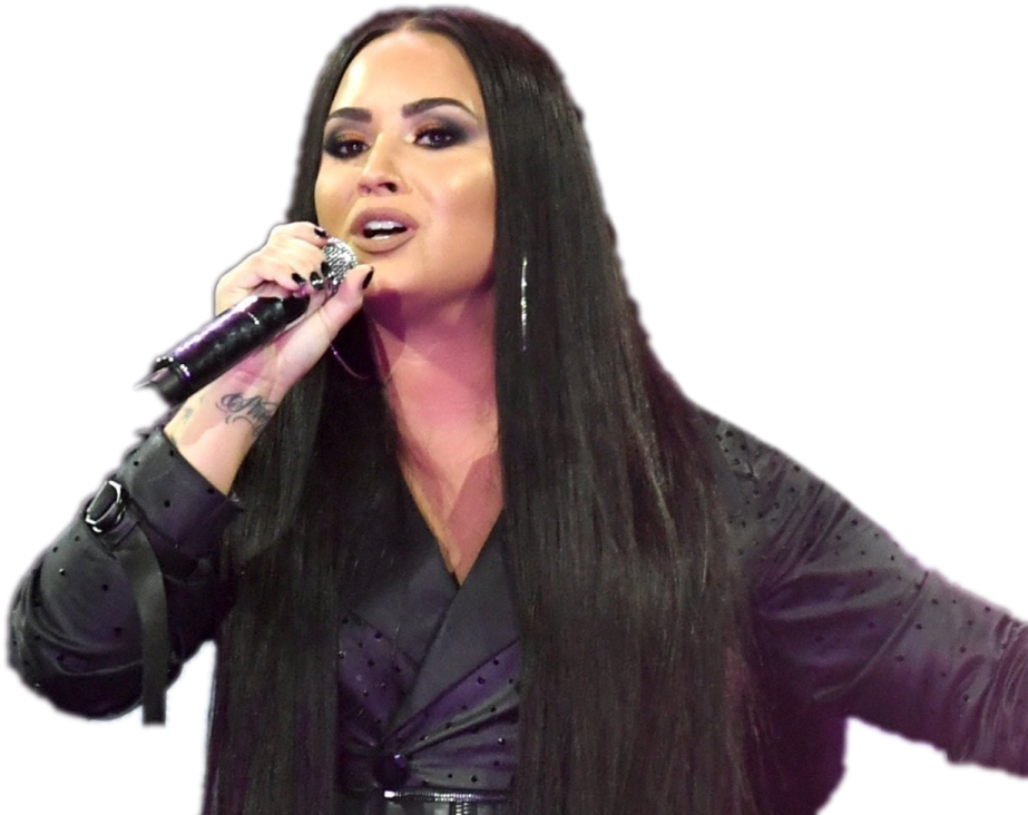 a woman with long black hair singing into a microphone