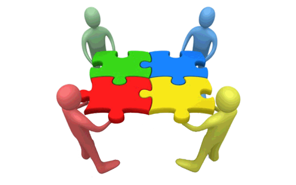 a group of people standing around a puzzle